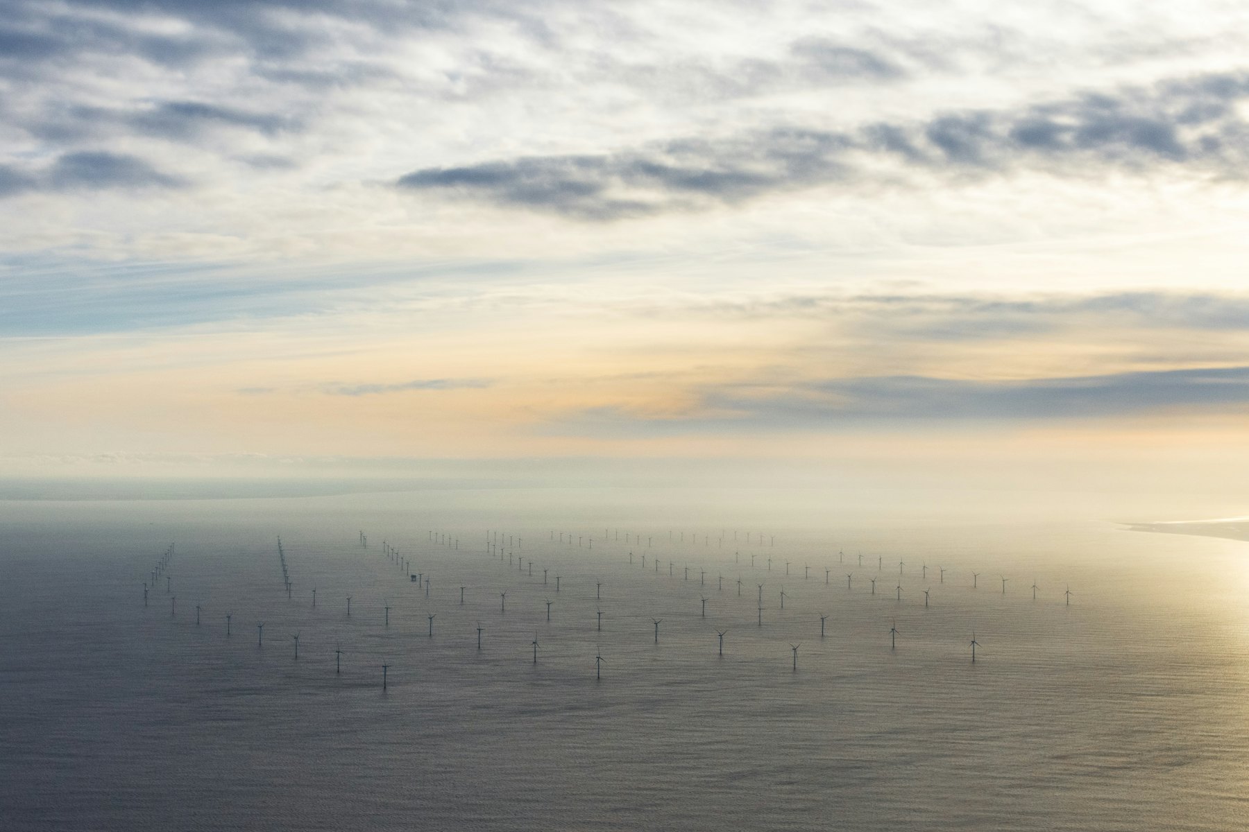 An offshore wind farm seen from the air in hazy light